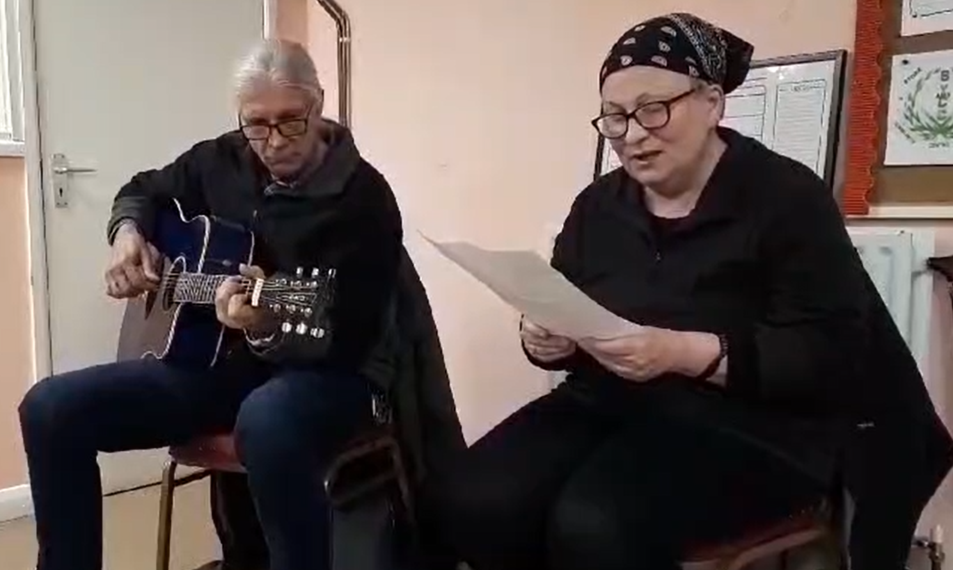 An old man sitting on his own